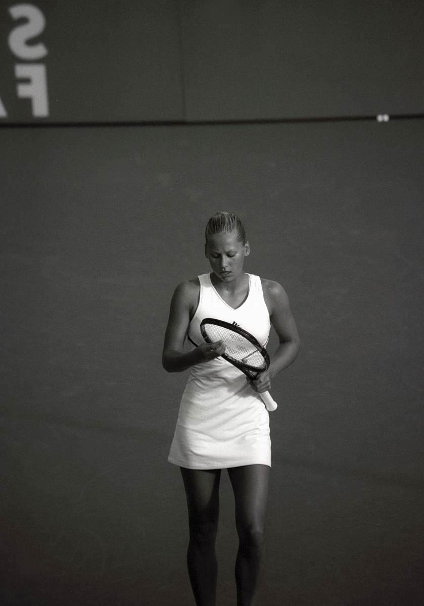 people woman wearing dress holding tennis racket black-and-white