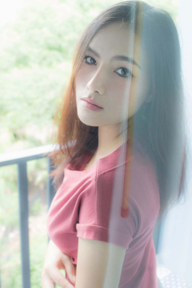 people woman wearing maroon scoop-neck shirt person