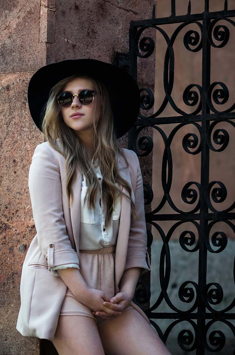 people woman wearing pink dress against the metal wall person