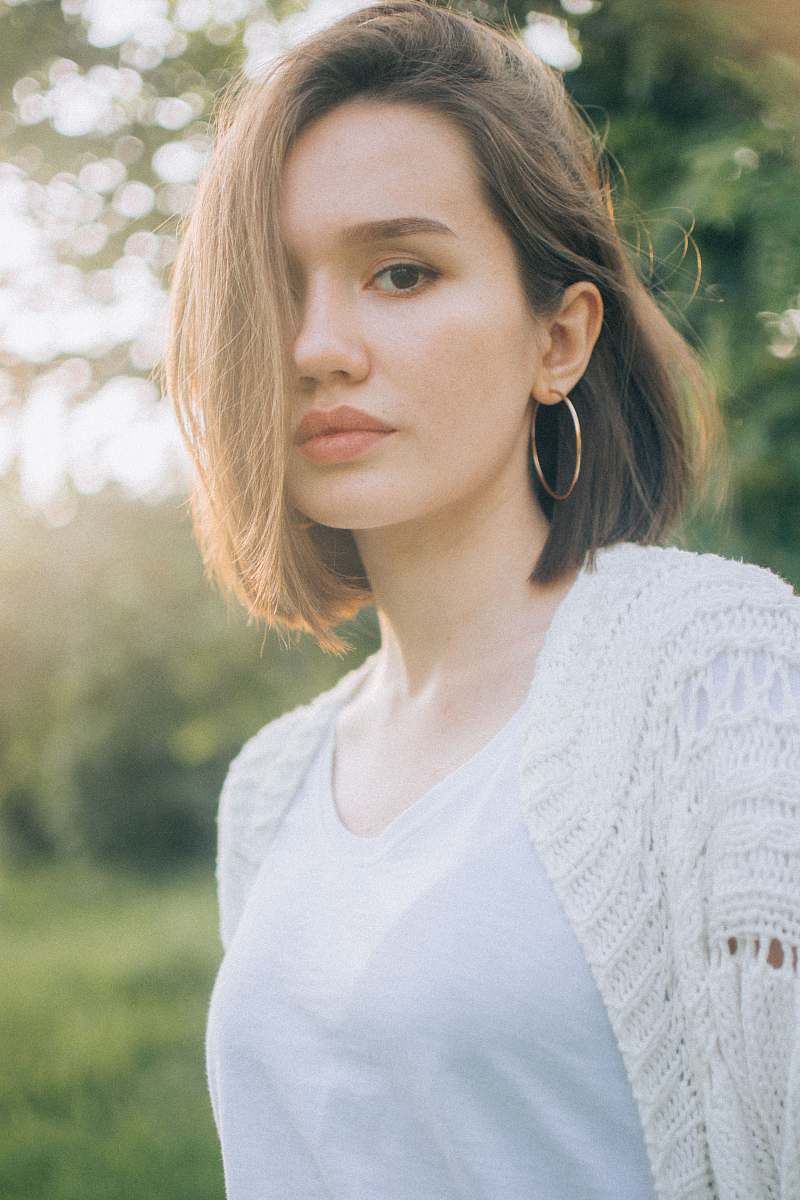people woman wearing white cardigan person