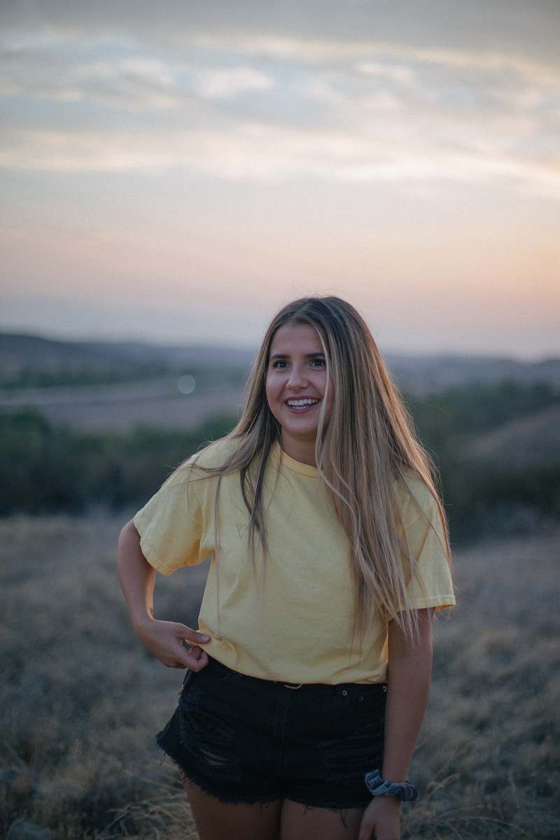 person woman wearing yellow shirt and black shorts at the field people