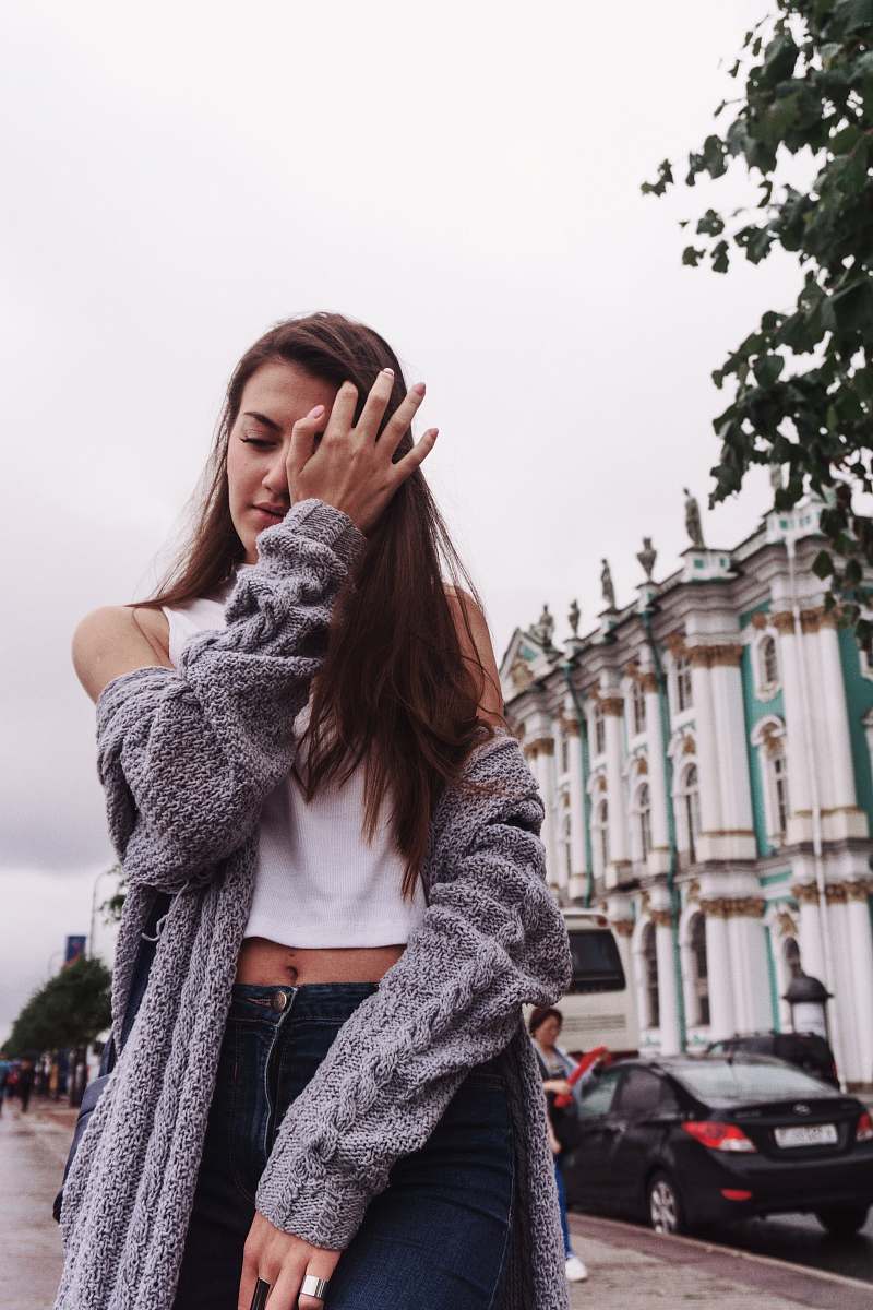 people woman wiping her eye on the sidewalk person