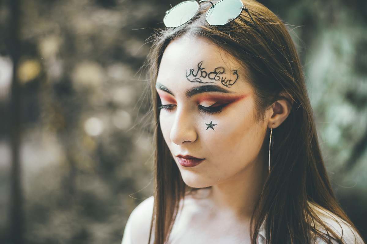 people woman with face paint wearing sunglasse s person