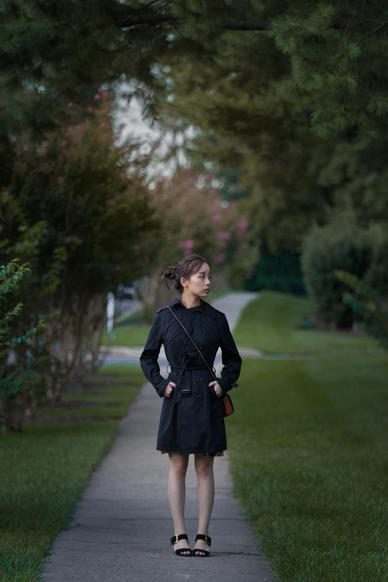 people women's black dress shirt standing on pathway person