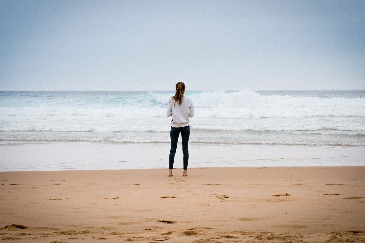beach woman standing near seashore during daytime sea
