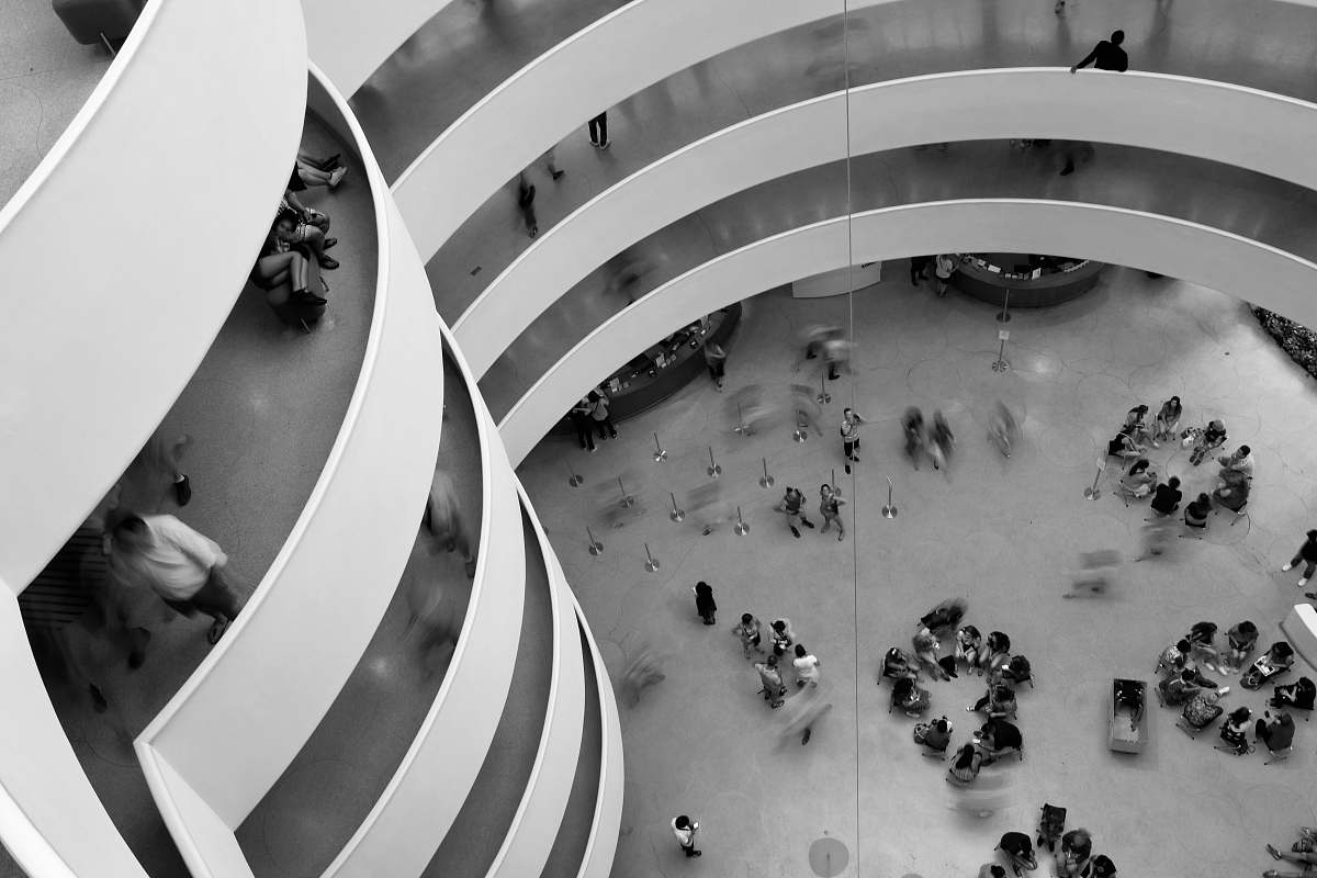 black-and-white aerial photo of group of people in building grey