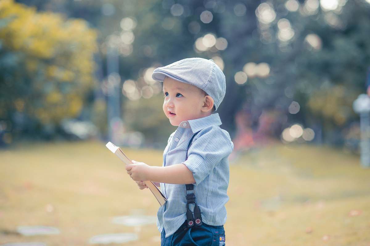 person boy holding book during daytime human