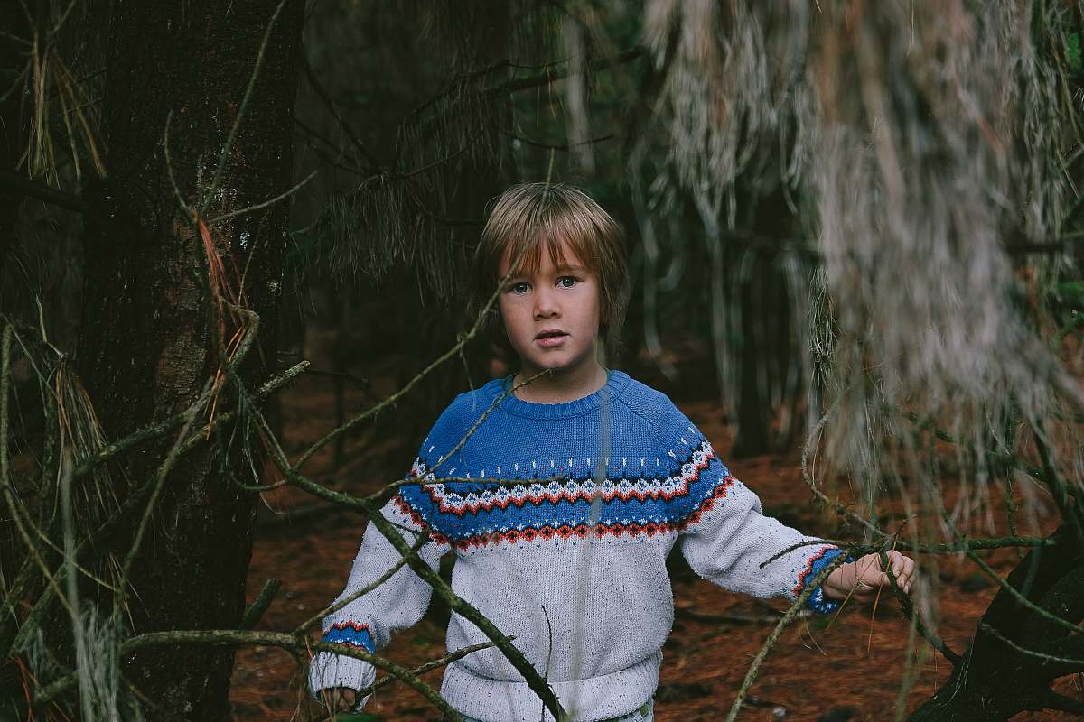 human boy standing near tree person