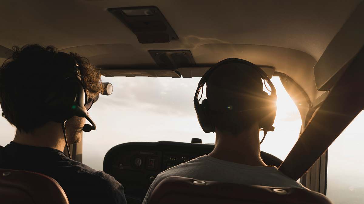 human closeup photo of two pilot and co pilot inside plane person