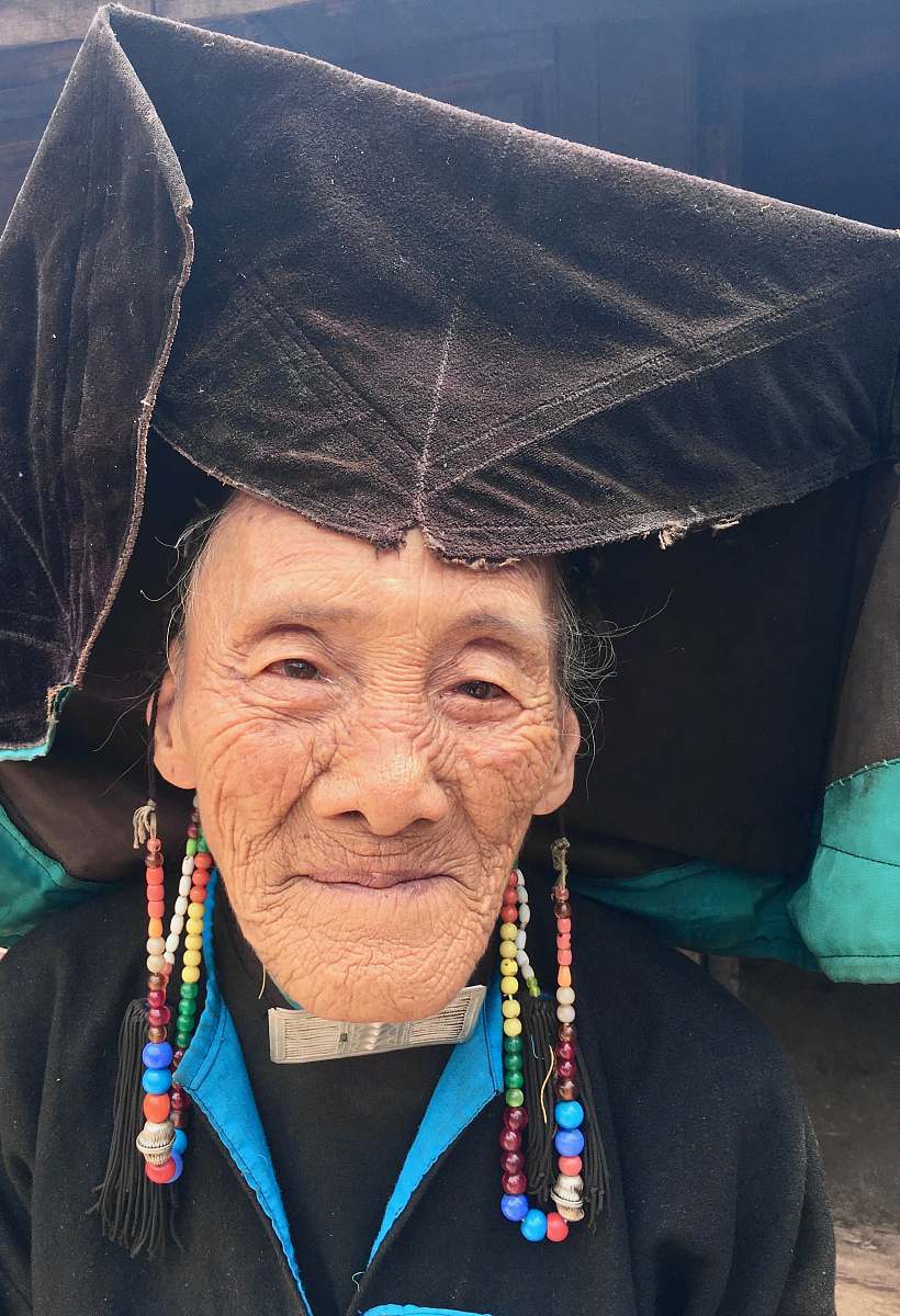 human closeup photo of woman wearing black hat and dress person