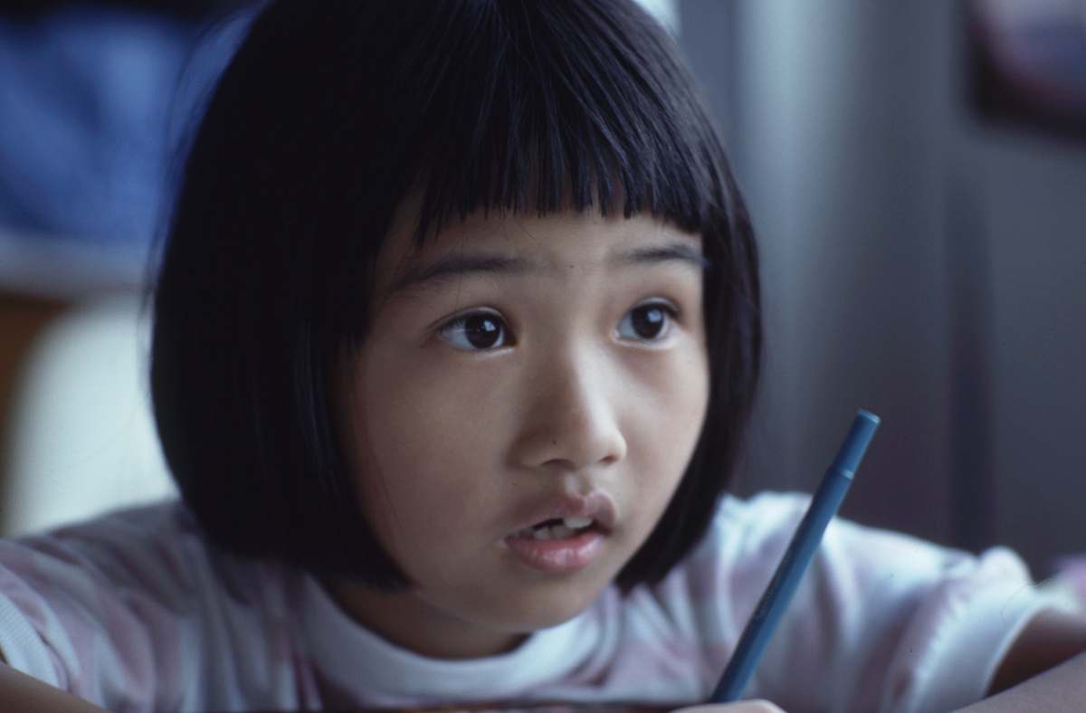 human girl holding pen girl