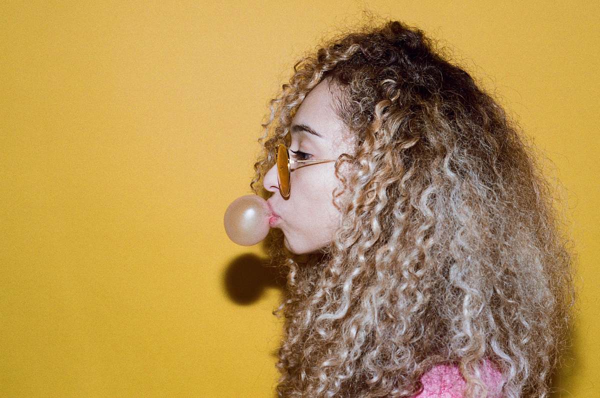 person girl making balloon using bubblegum human