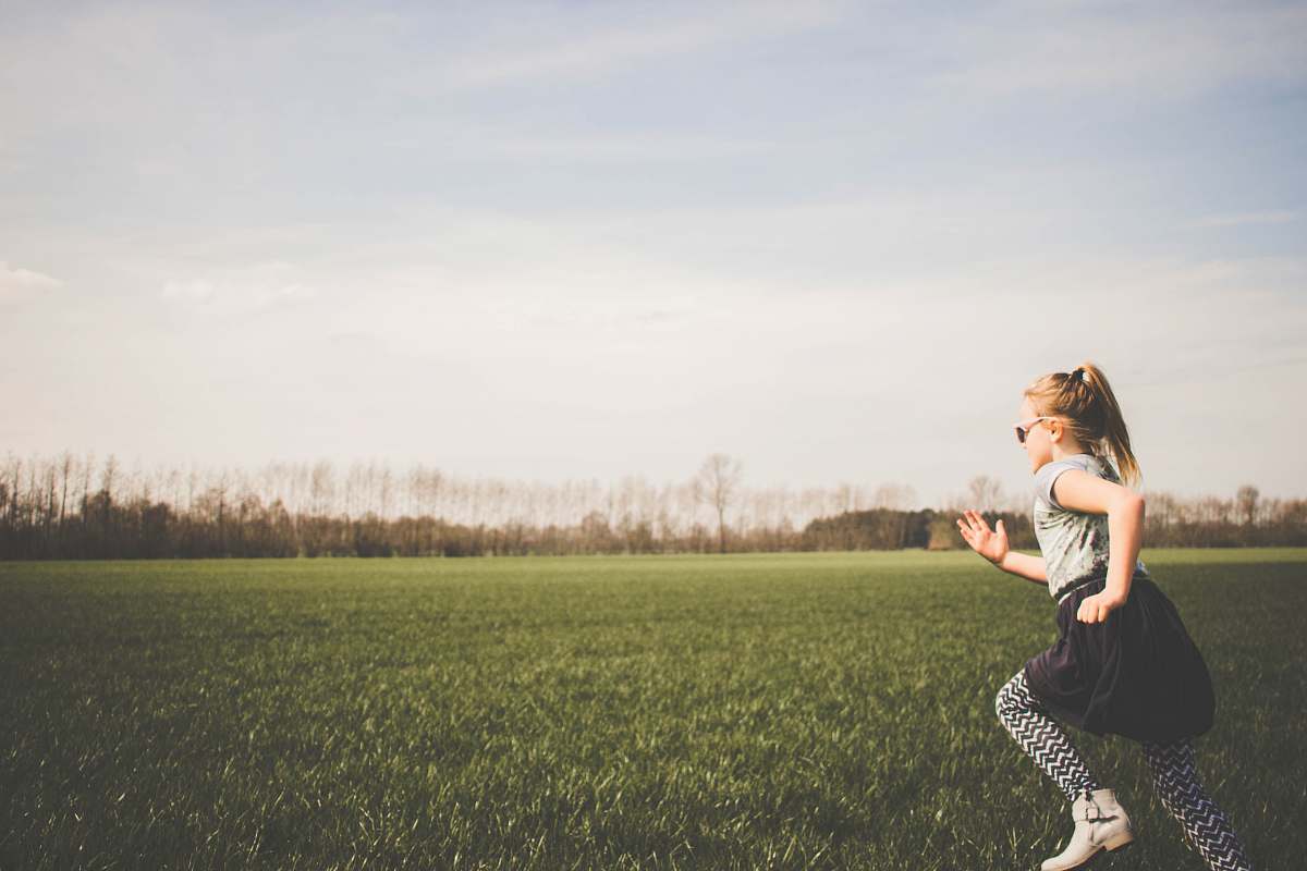 human girl running on grass field kid
