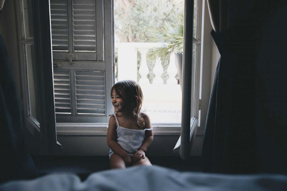 person girl sitting by the window during daytime human