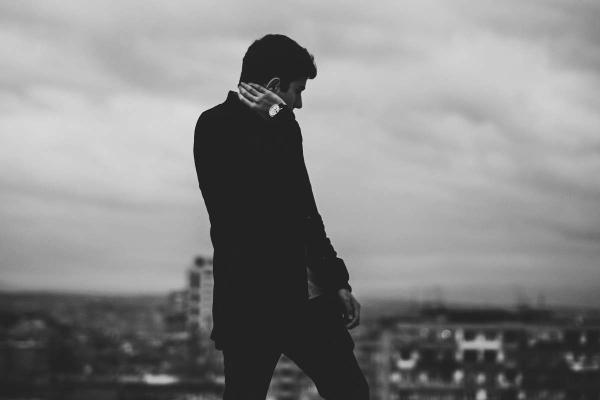 human gray scale man on top of the building black-and-white