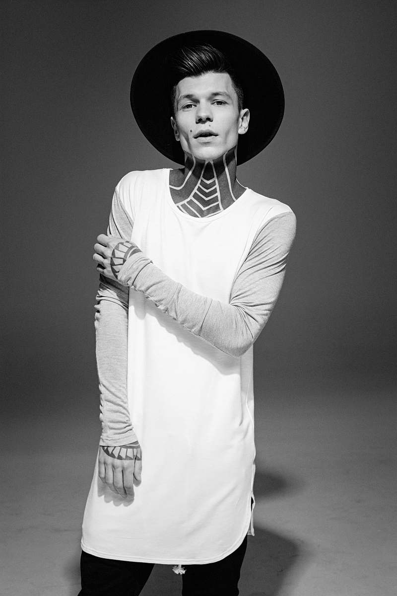 human grayscale photo of a man wearing gray long-sleeved shirt black-and-white