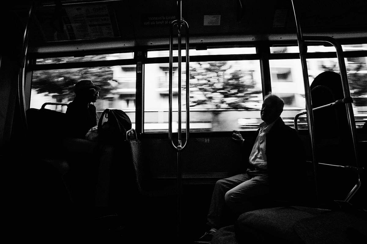 person grayscale photo of several people on moving train black-and-white