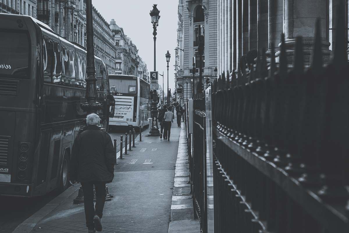 human grayscale photography of people walking on sidewalk grey