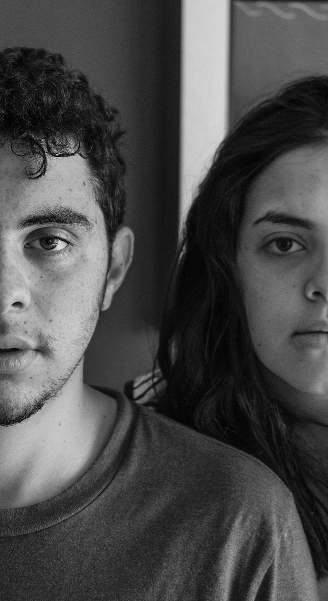 person grayscale photography of woman behind man black-and-white
