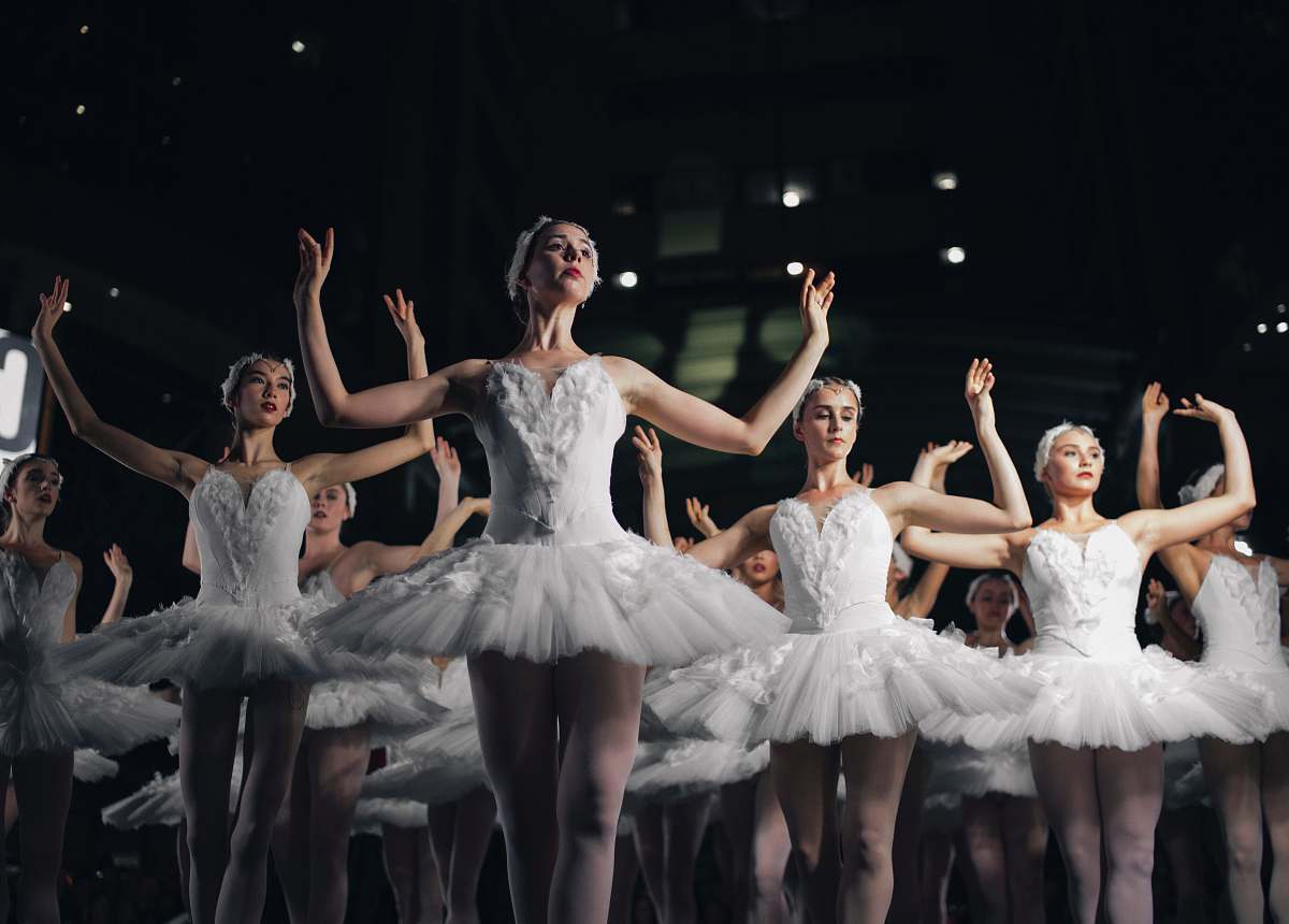 ballet group of ballerinas dancing while raising both hands dance