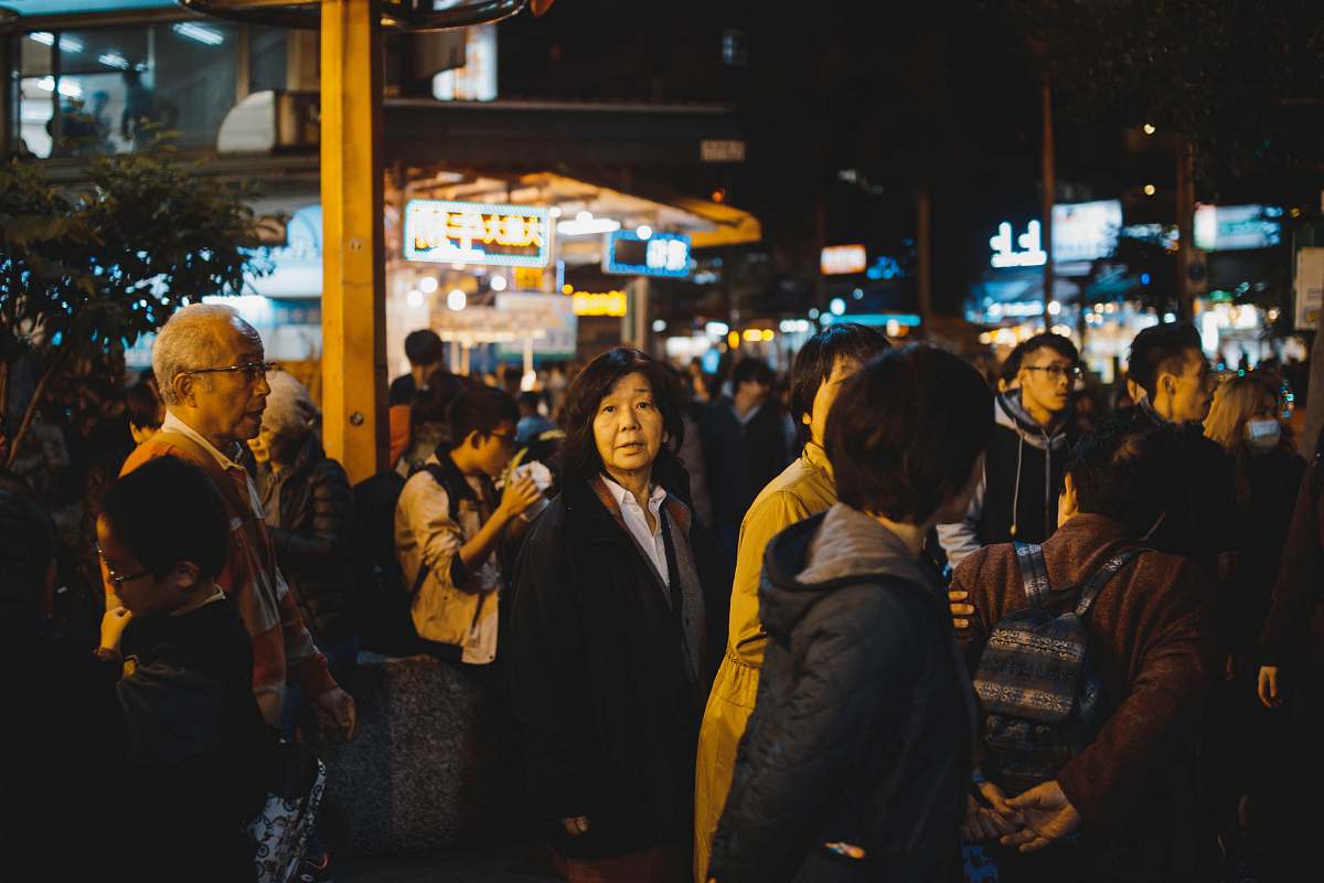 During night time. Dark crowd.