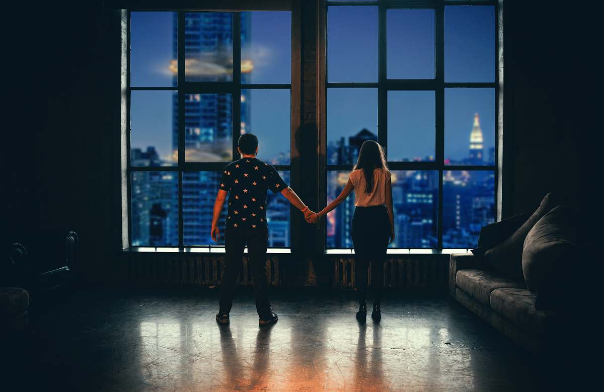 human man and woman holding hands in front of glass window person