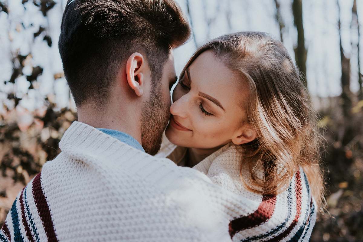 person man and woman kissing during daytime human