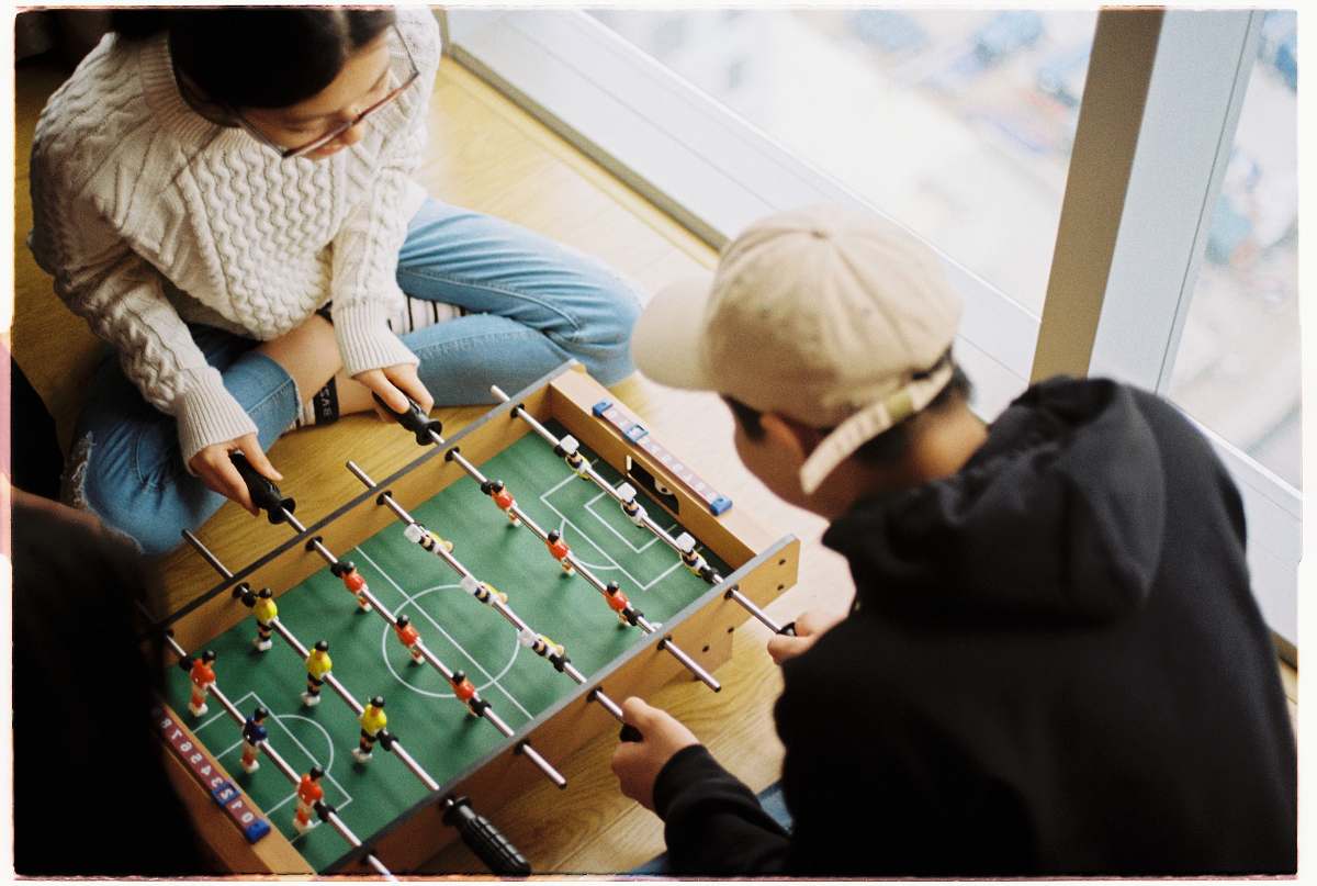 human man and woman playing foosball table person