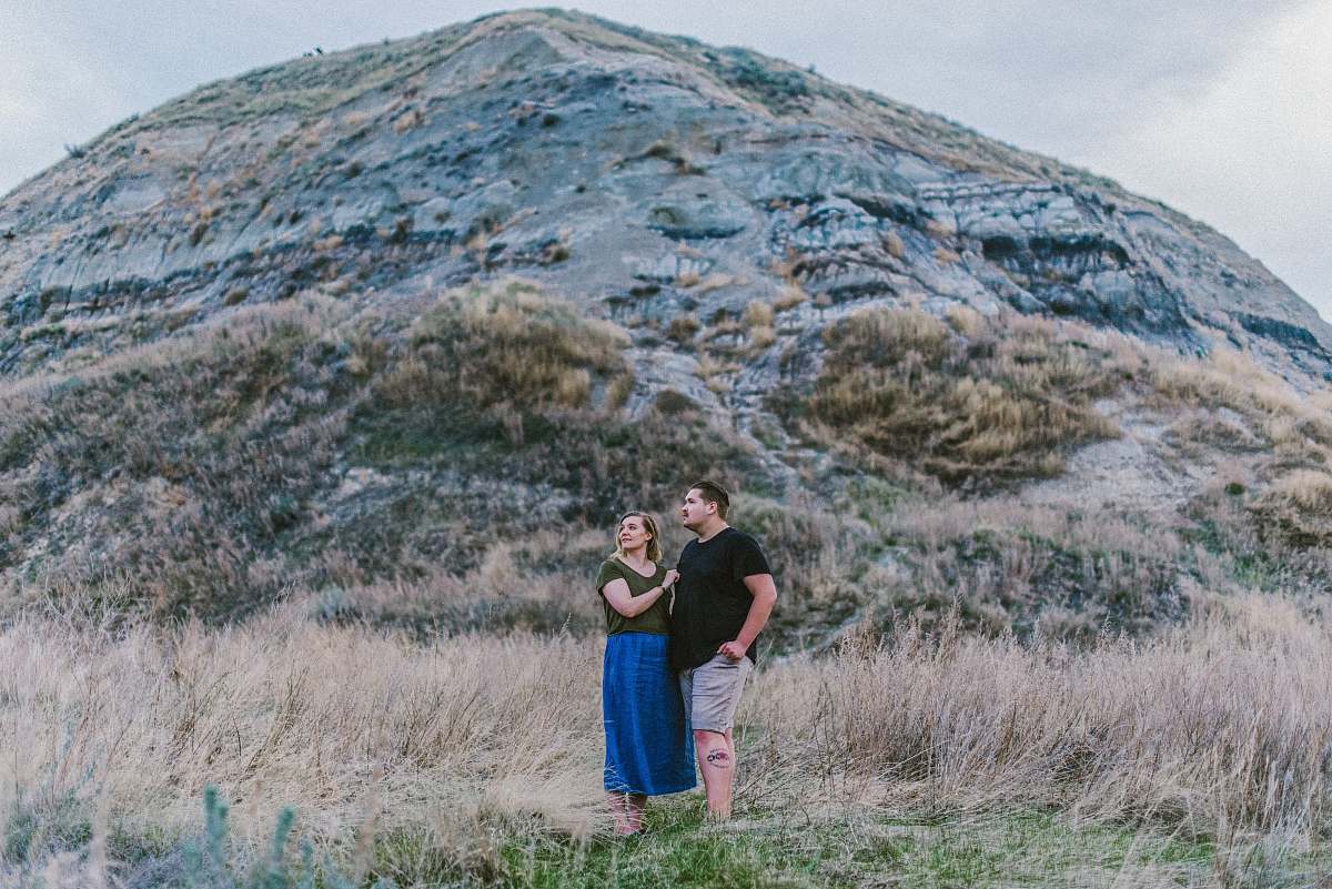 human man and woman standing near mountain person