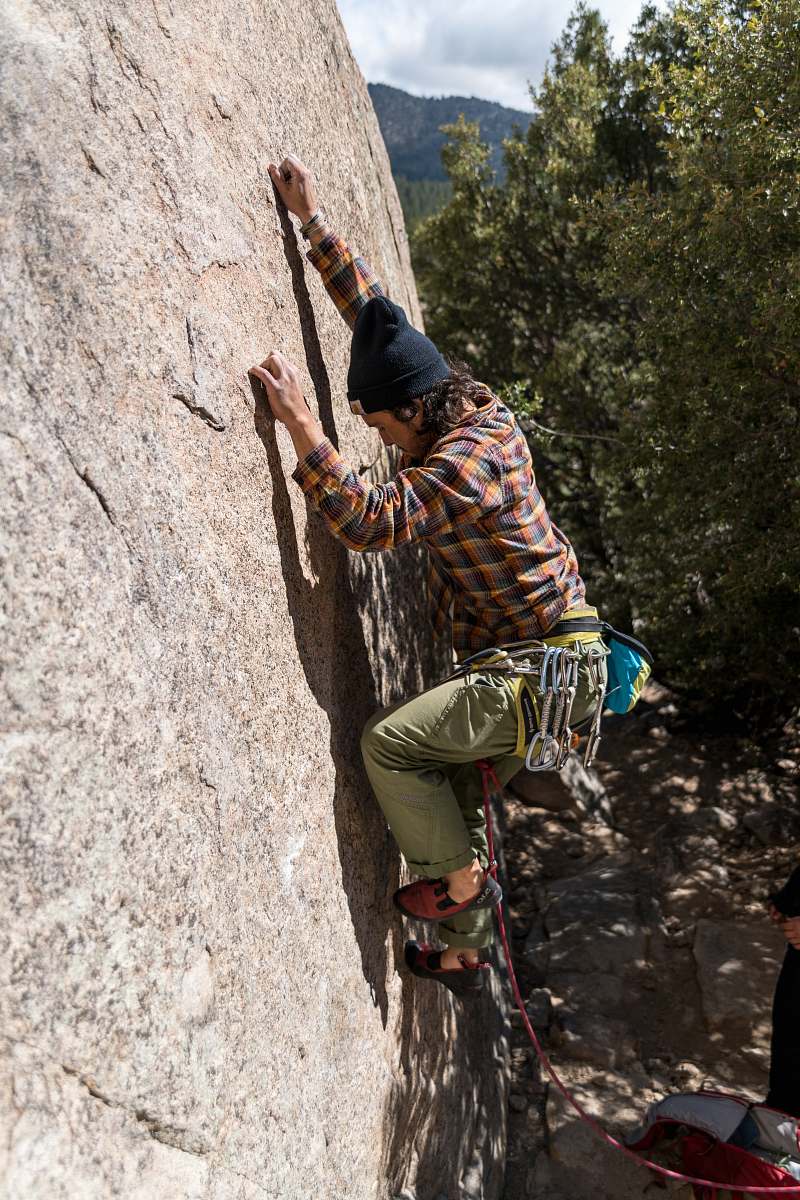 person man climbing on rock during daytime human
