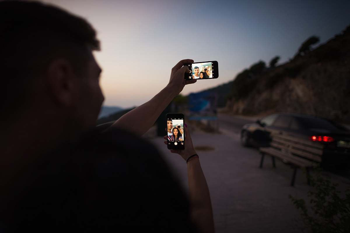 person man holding smartphone during daytime human