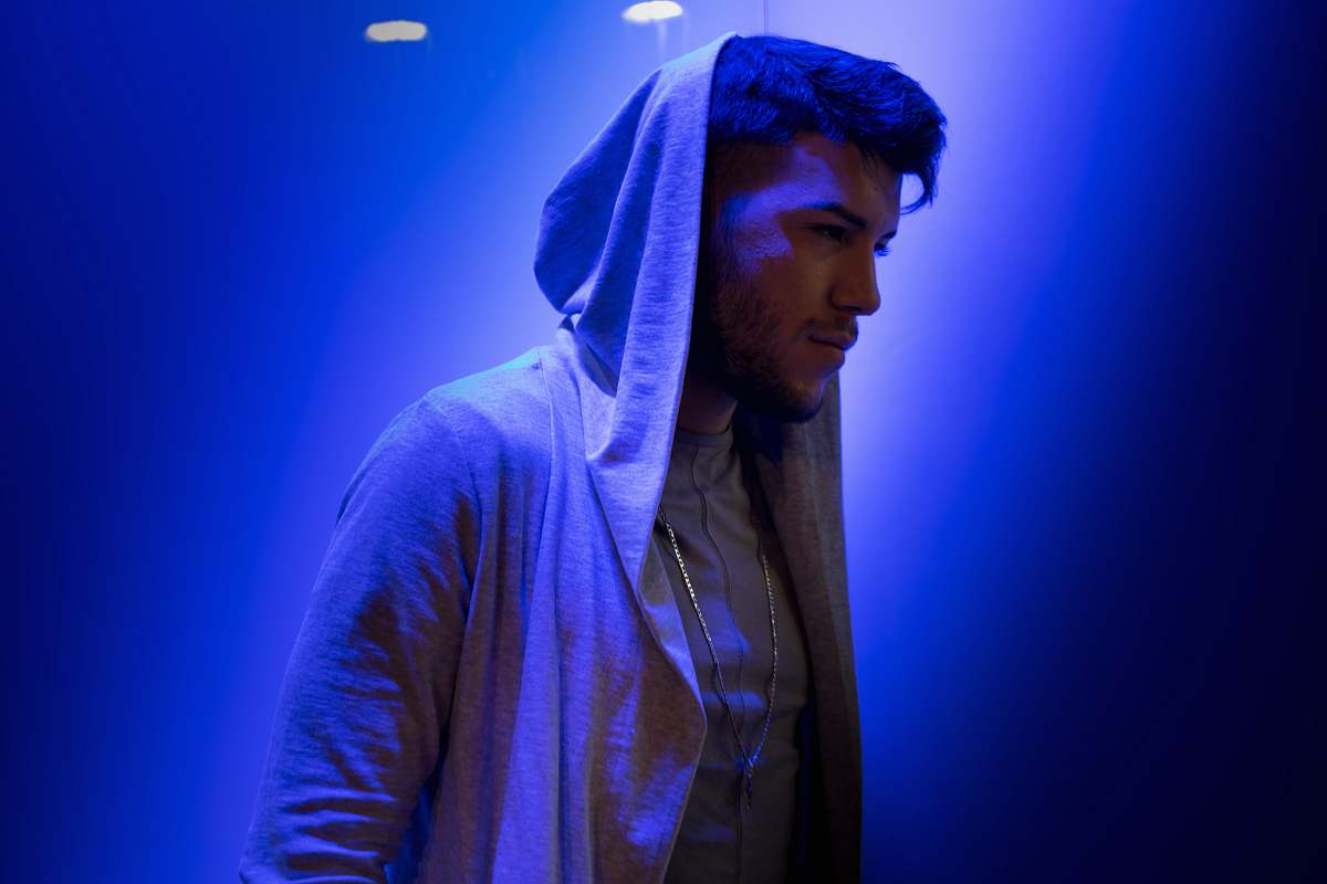human man i hood on standing on blue background person