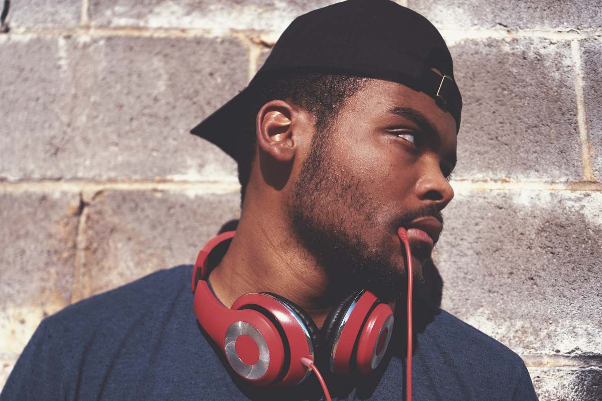 person man in blue shirt with red corded headphones human