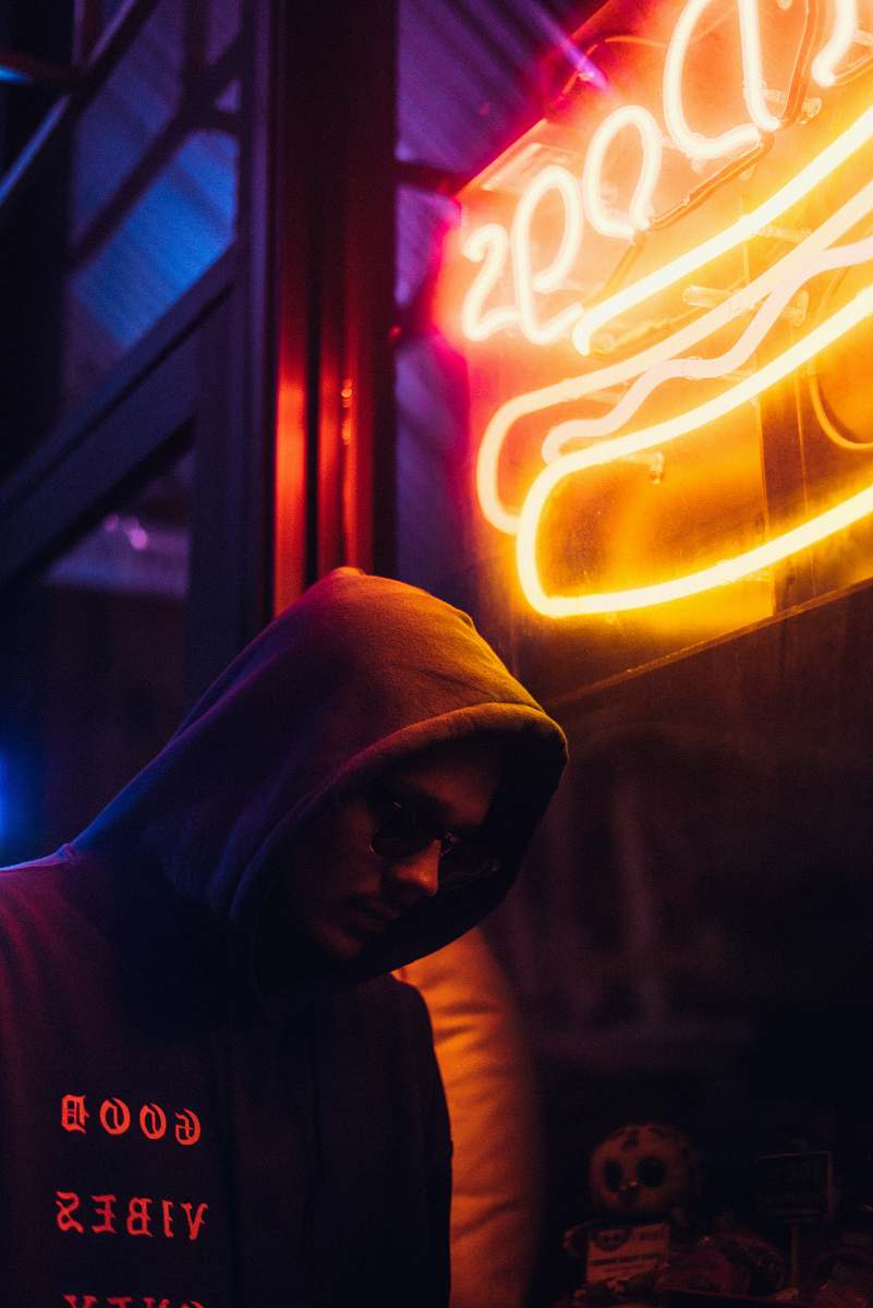 person man looking down with text overlay neon