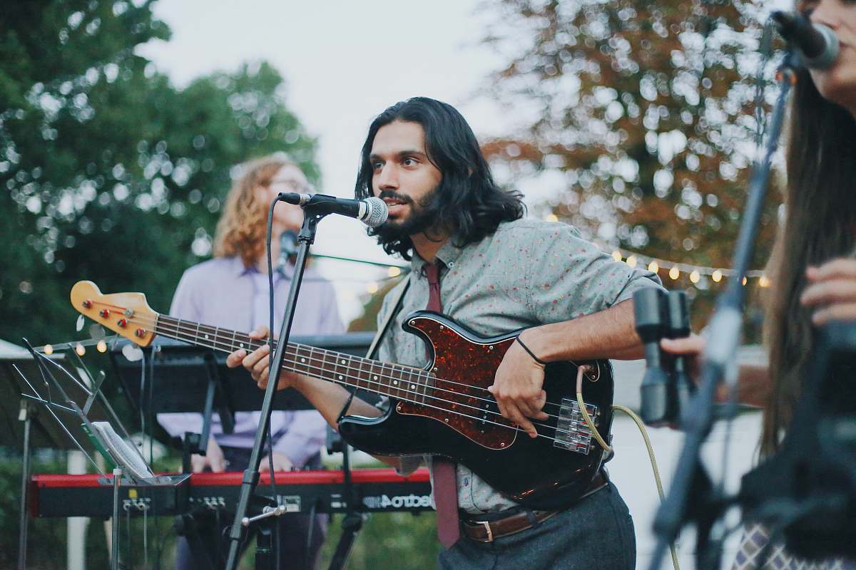 person man playing as electric bass guitar guitar