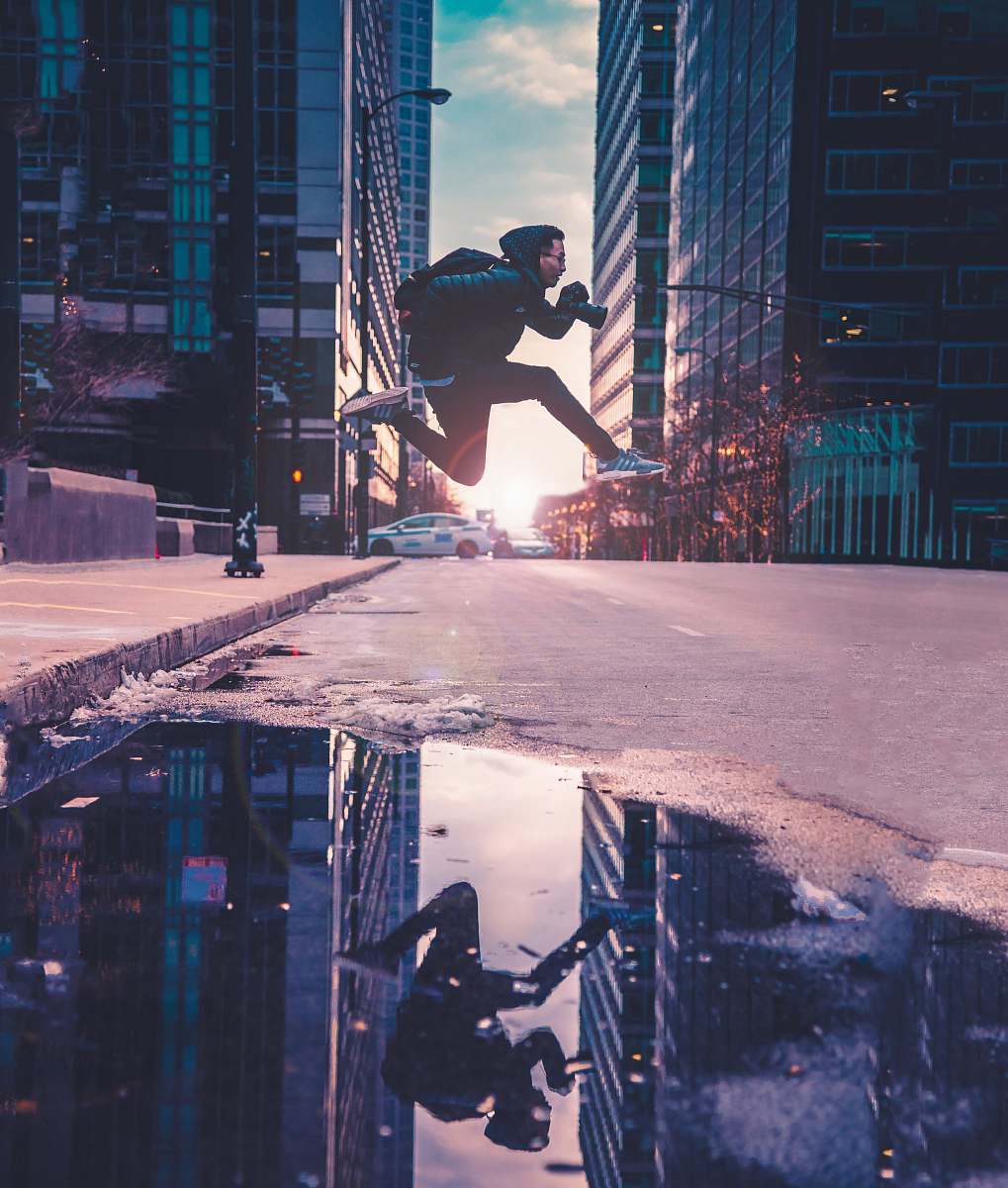 person man running across street with buildings human