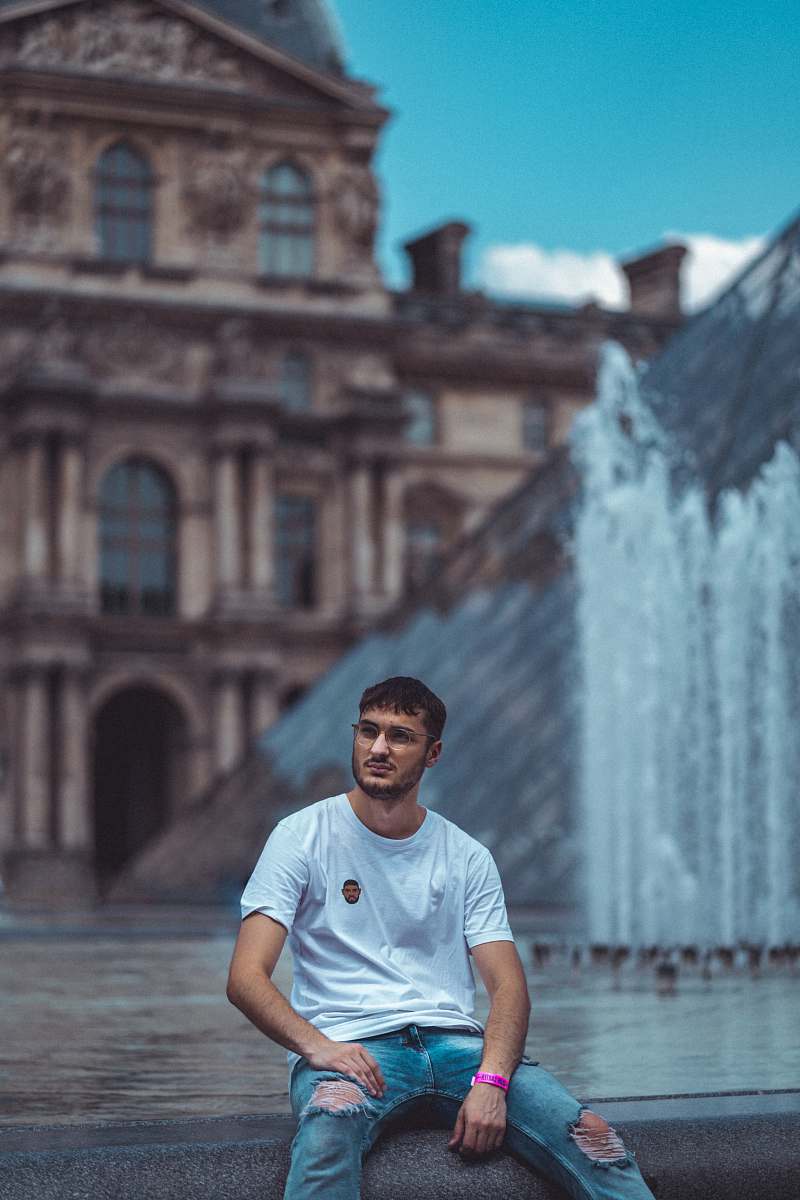 person man sitting beside fountain human