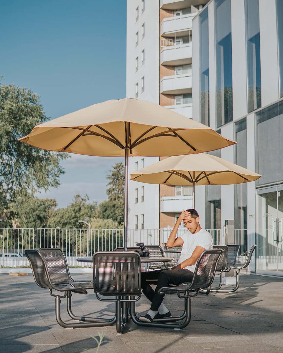 person man sitting on black metal chair chair