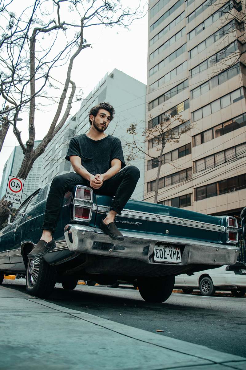 human man sitting on classic car person