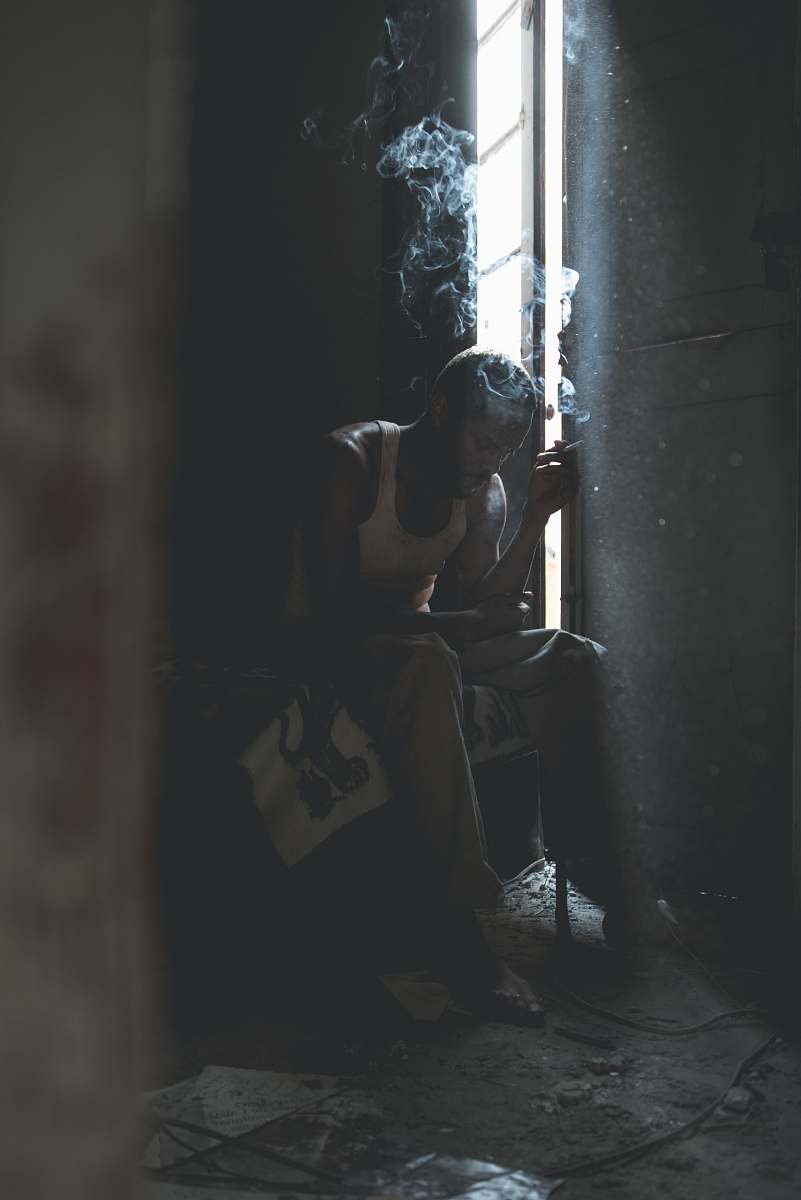 human man smoking sitting on chair person