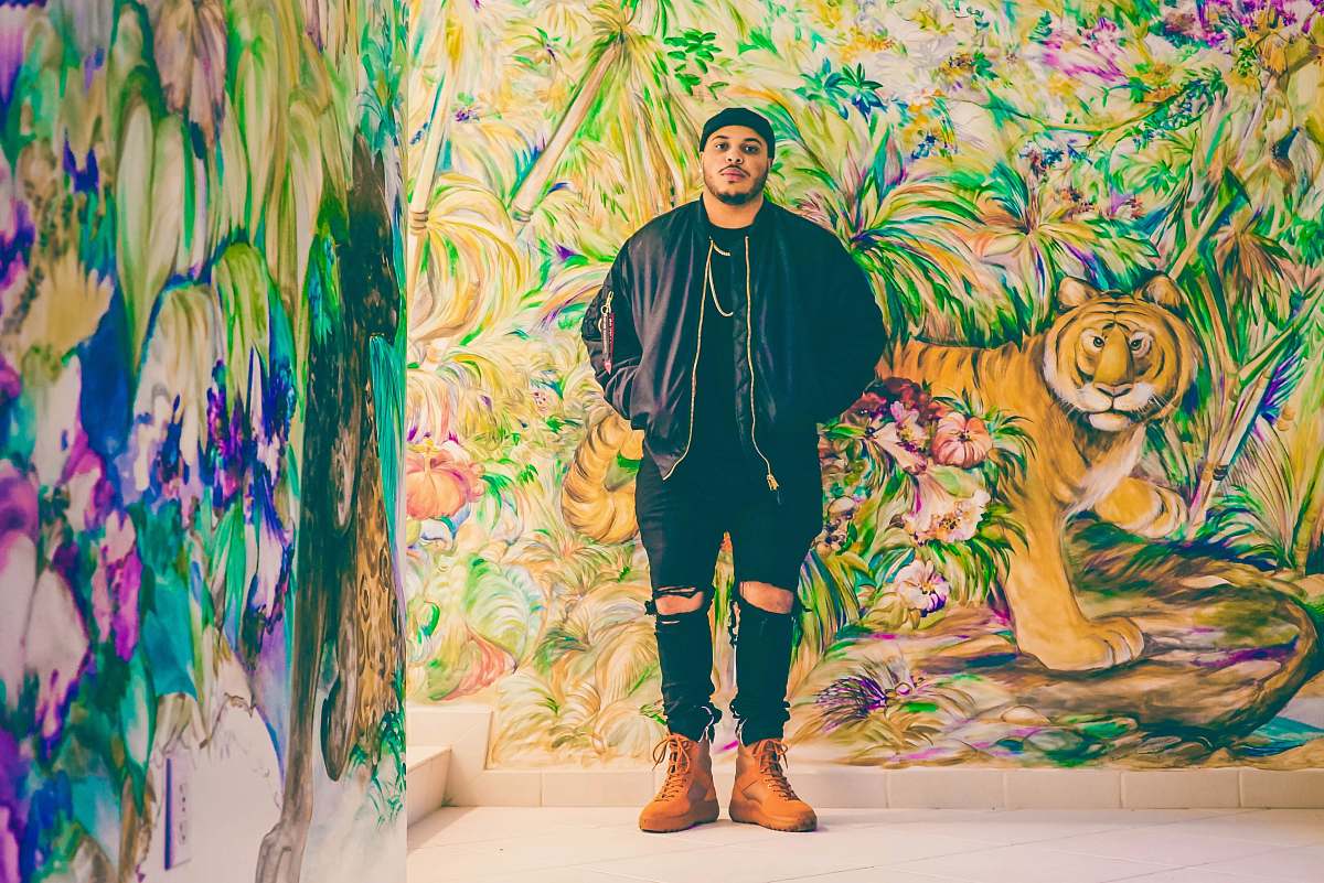 human man standing behind assorted-design graffiti person