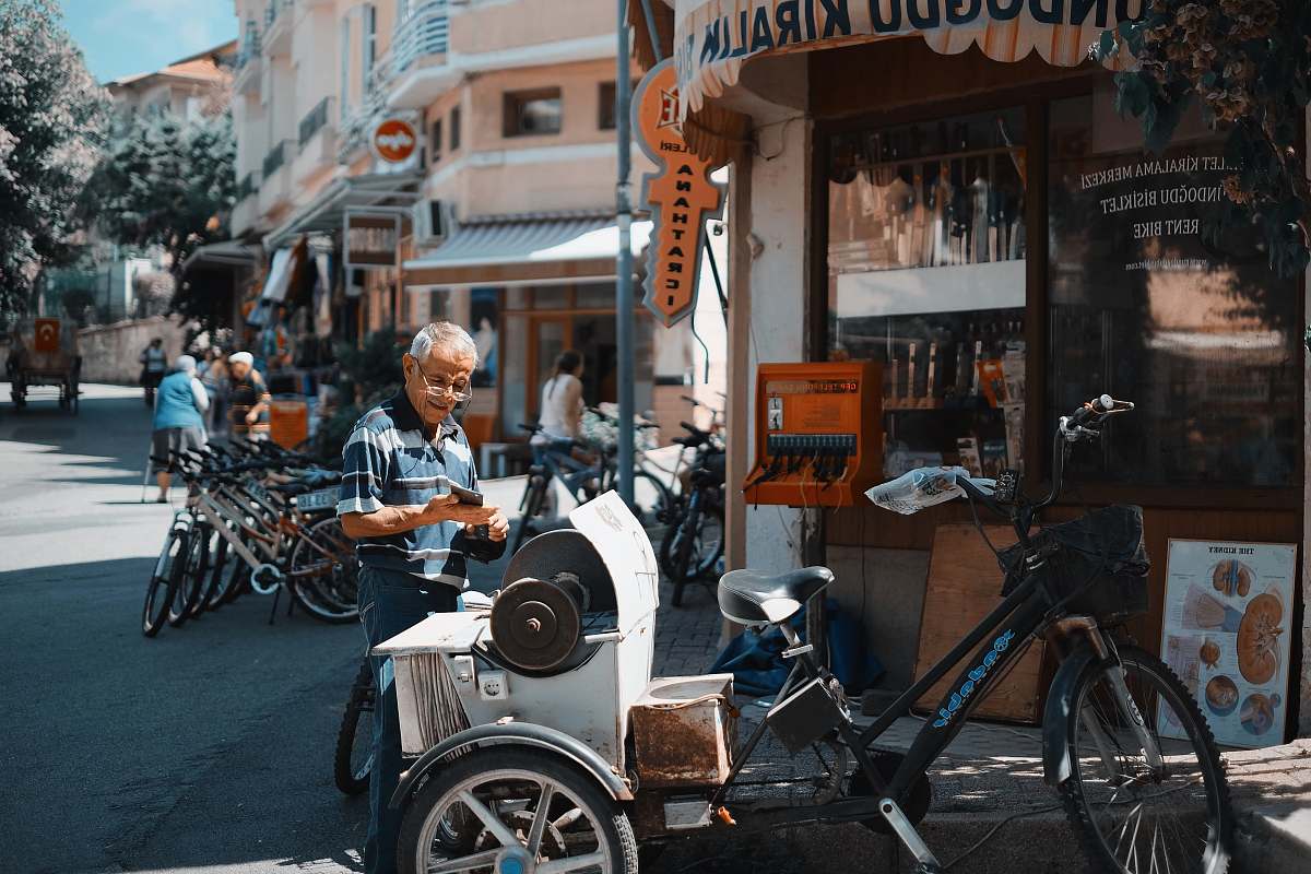 bike man standing behind the trile bicycle