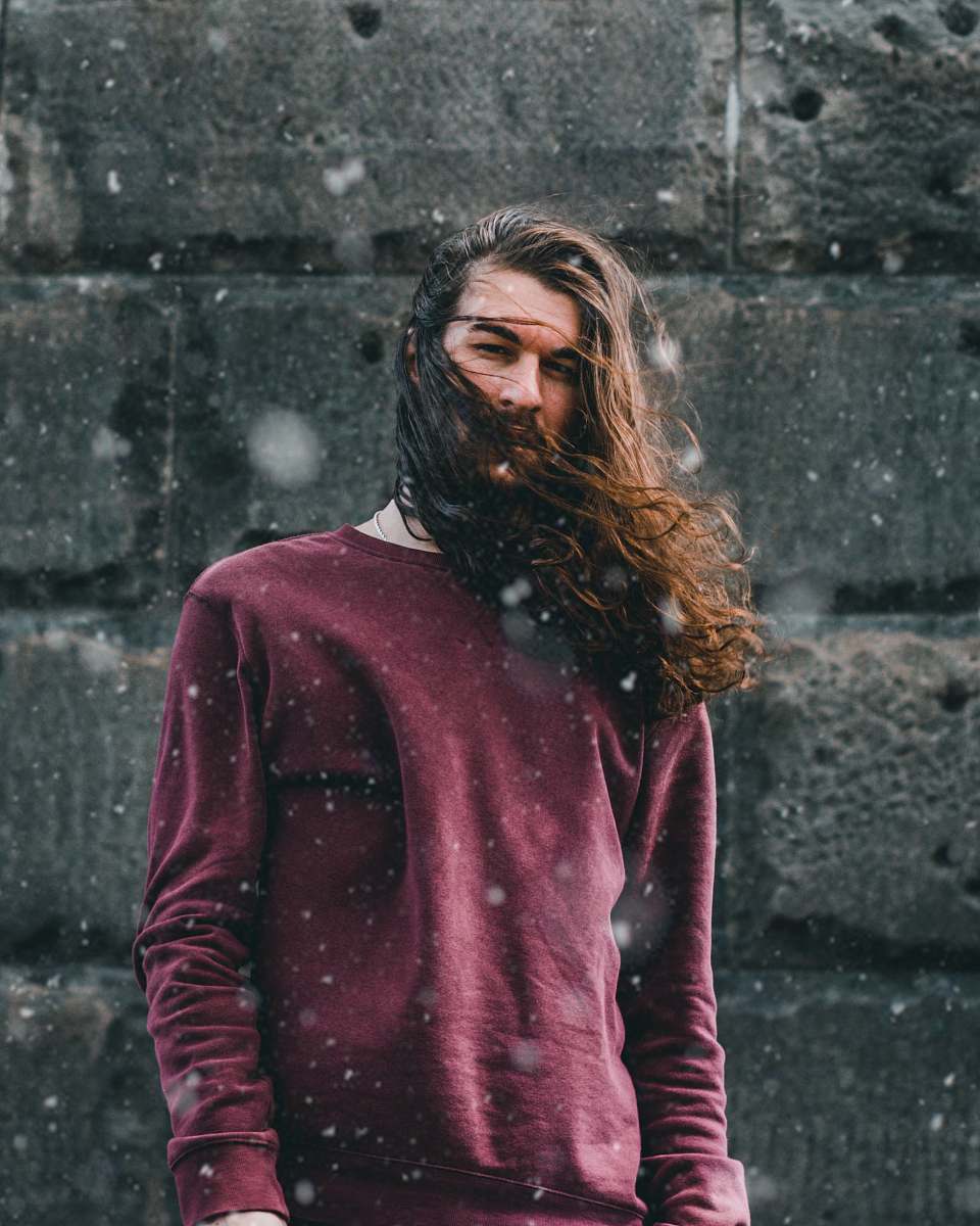 human man standing in front of black wall person