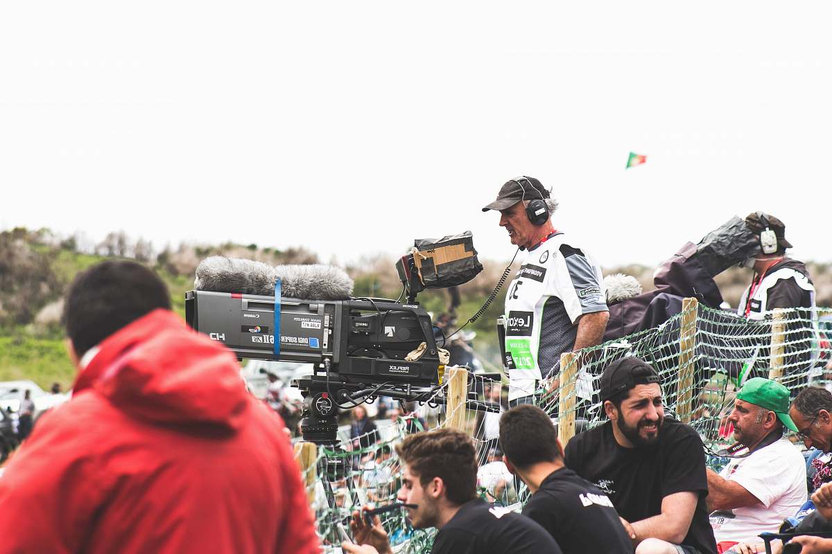 human man standing near black and gray video camera person