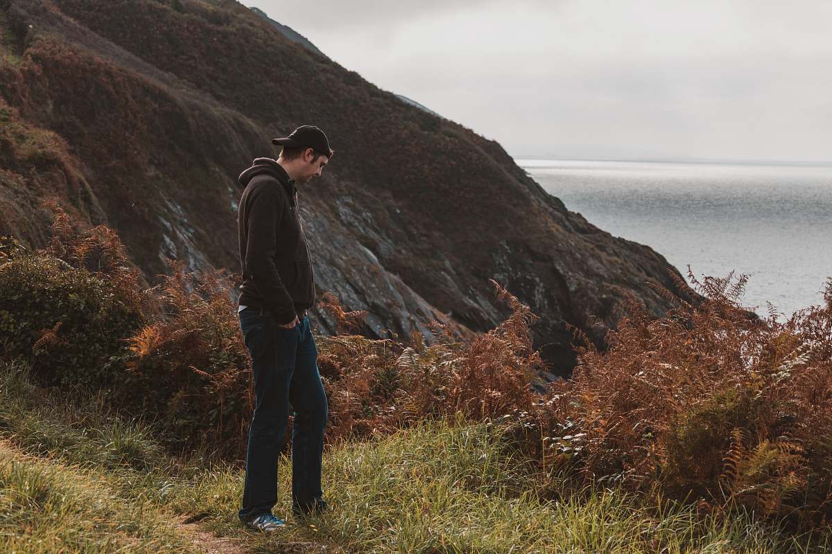 person man standing near mountain cliff human