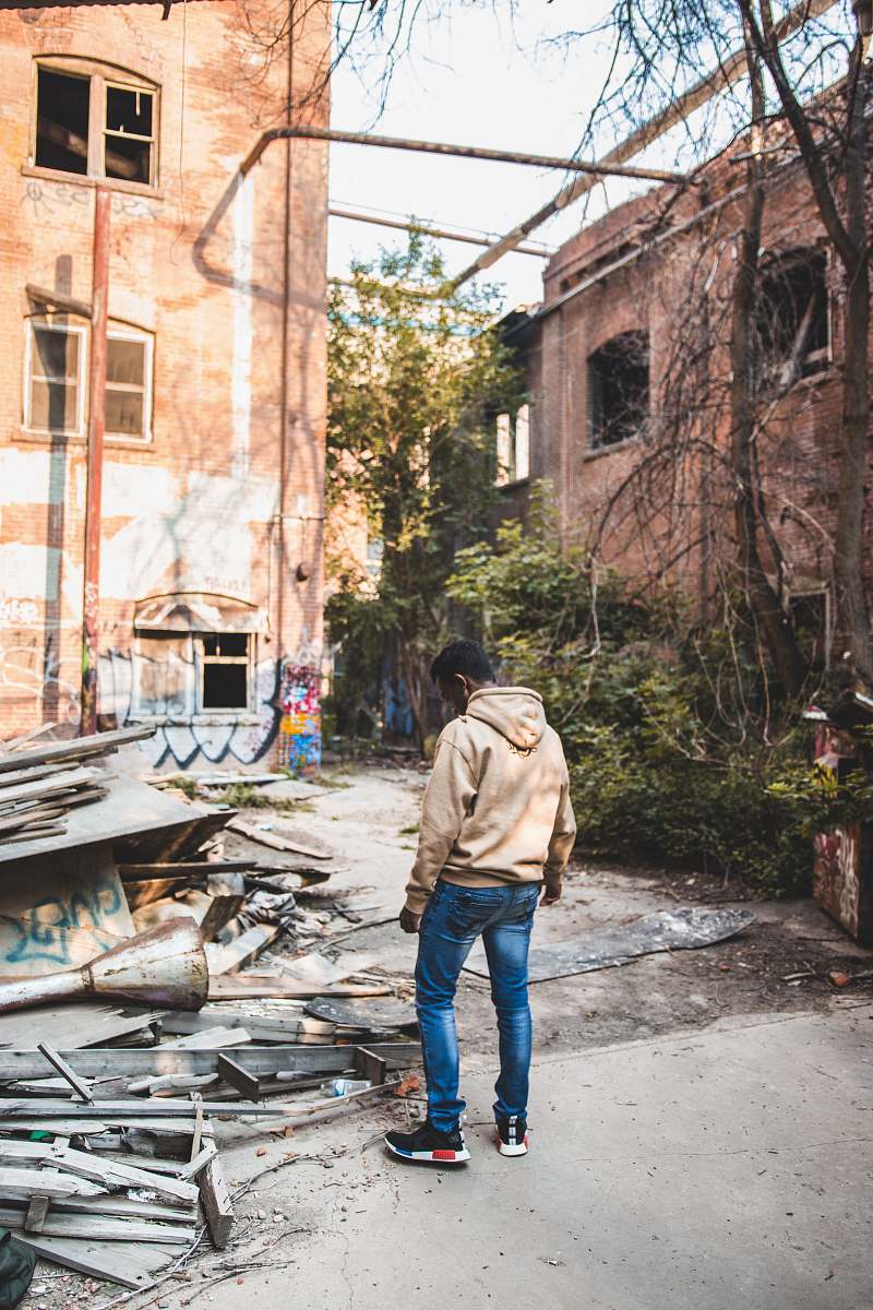 person man standing nearby metal frames human