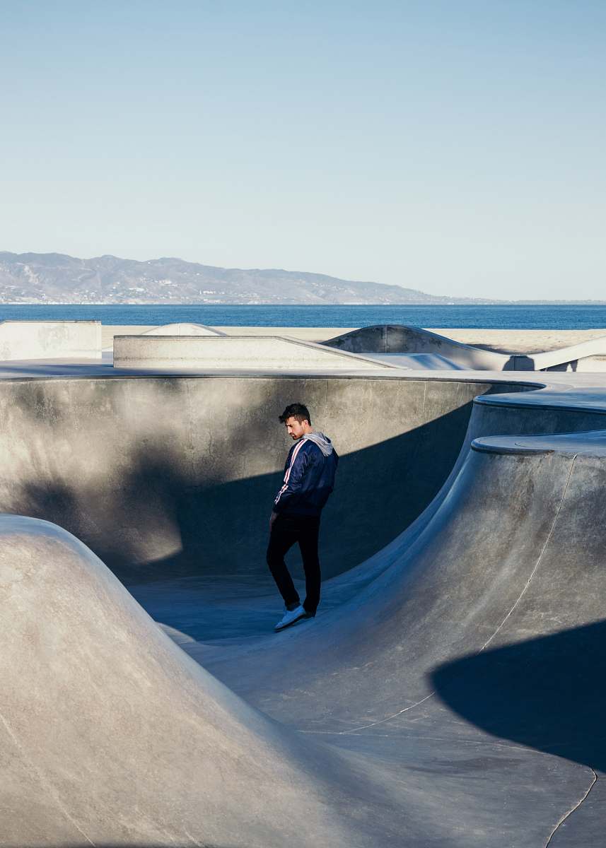 person man standing on bicycle ram under blue sky human