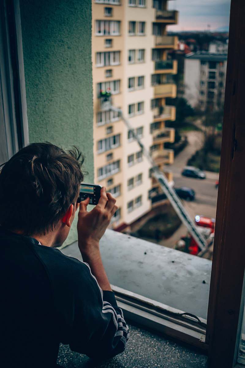 Capture the essence of urban life with this striking image of a man thoughtfully looking out the window at a bustling city. This moment encapsulates reflection and inspiration, making it perfect for articles on city living, photography, or personal growth. Ideal for use in blogs, marketing materials, and social media campaigns aimed at lifestyle, travel, or photography enthusiasts.