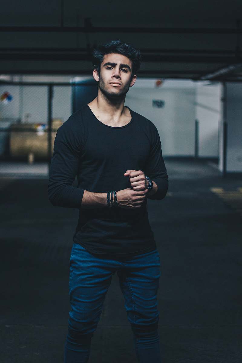 human man wearing black crew-neck long-sleeved t-shirt person