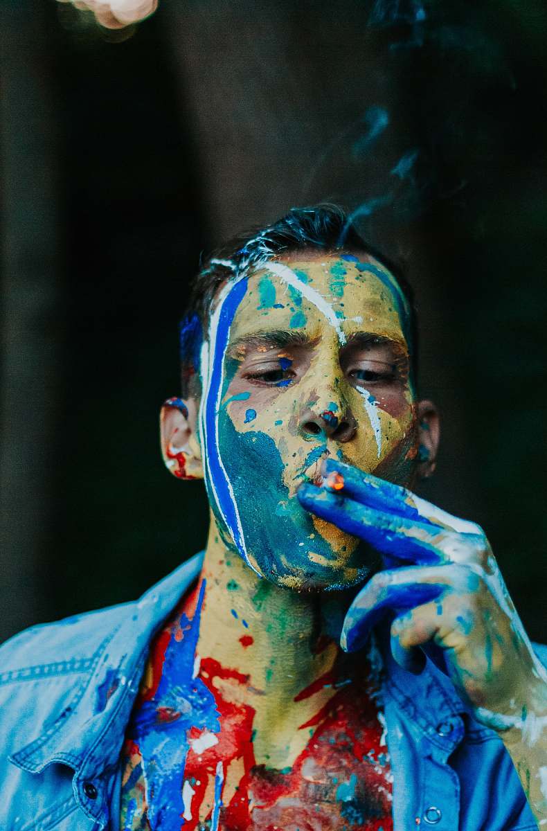 human man wearing blue shirt while smoking person